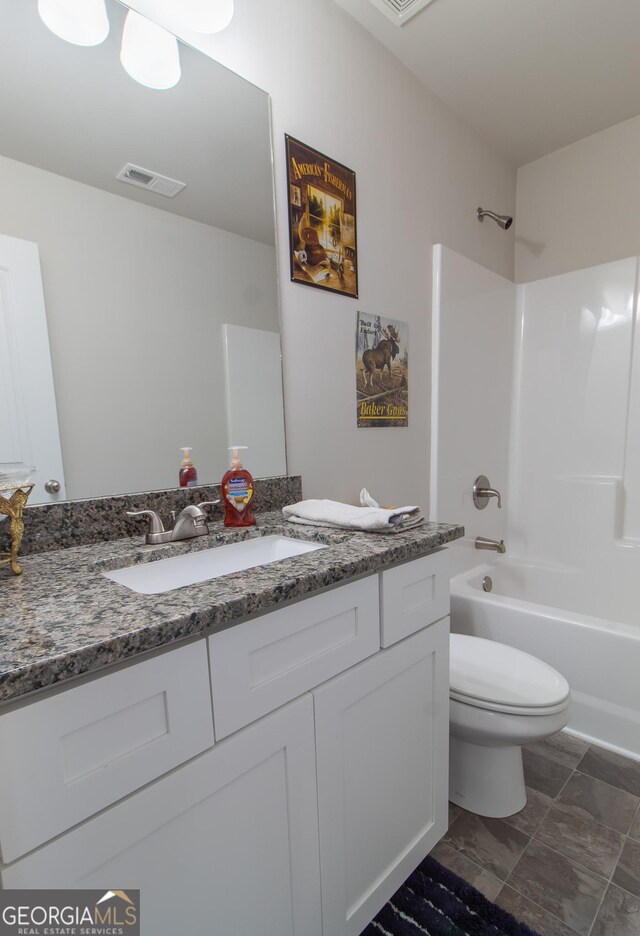 full bathroom featuring vanity, toilet, and  shower combination