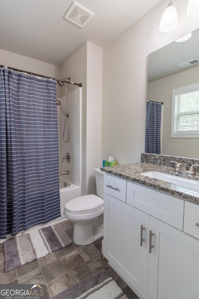 full bathroom with vanity, toilet, and shower / bath combo