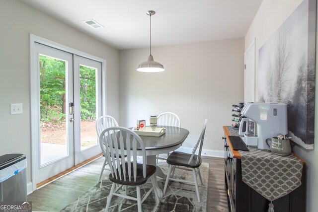 dining space with french doors and dark hardwood / wood-style flooring