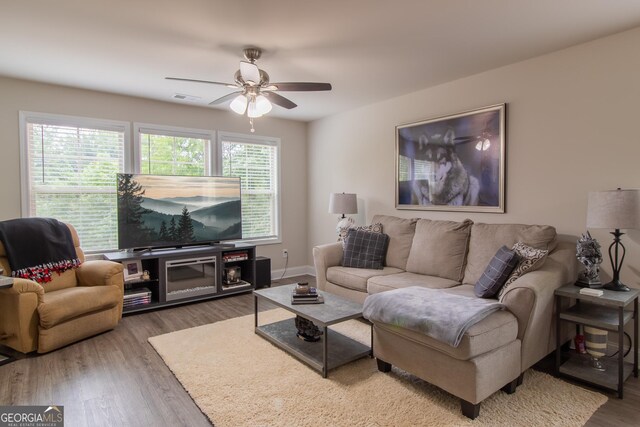 living room featuring hardwood / wood-style floors and ceiling fan