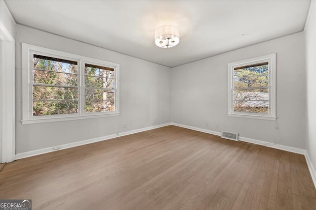 unfurnished room with wood-type flooring