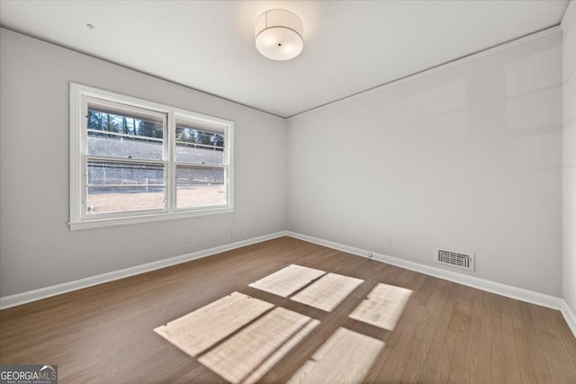 empty room with wood-type flooring