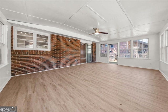 unfurnished sunroom with ceiling fan