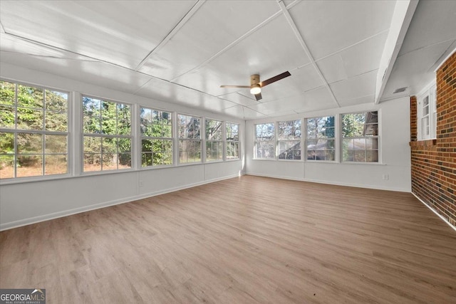 unfurnished sunroom with ceiling fan