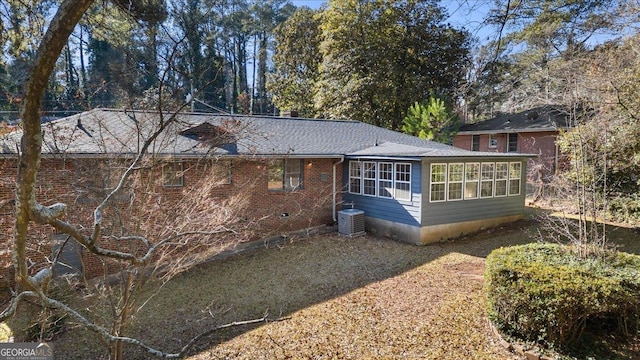 rear view of property with central AC