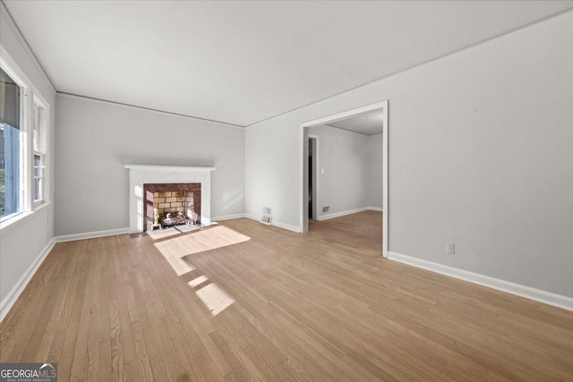 unfurnished living room featuring light hardwood / wood-style floors and a premium fireplace