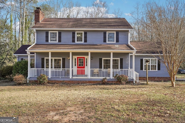 view of front of property with a porch and a front lawn