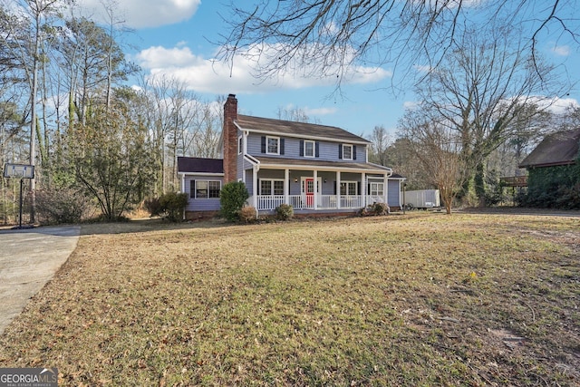 view of front of home featuring covered porch and a front lawn