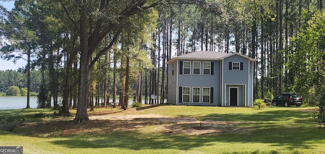 view of side of home with a yard