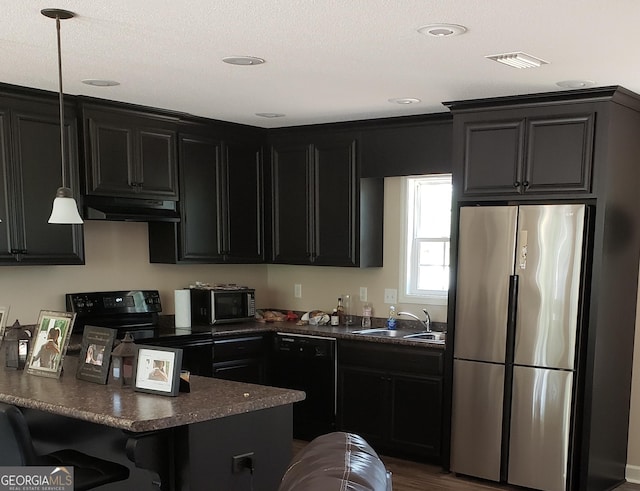 kitchen with dark wood-type flooring, sink, black appliances, and decorative light fixtures