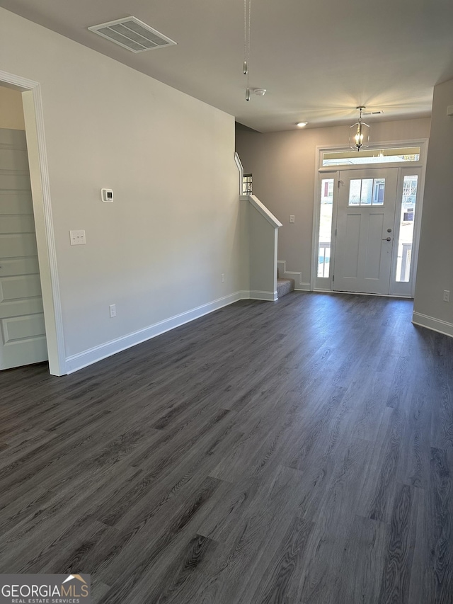 foyer entrance with dark wood-type flooring