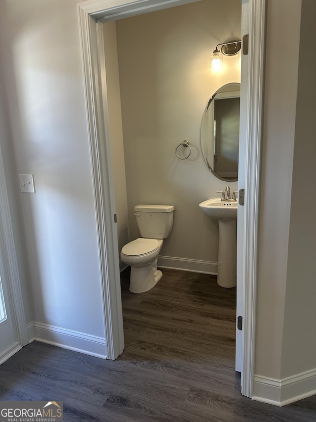 bathroom with sink, wood-type flooring, and toilet