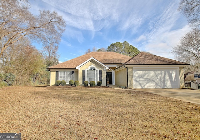 ranch-style home featuring a garage and a front lawn