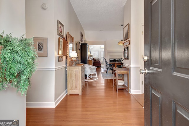 entryway with hardwood / wood-style floors and a textured ceiling