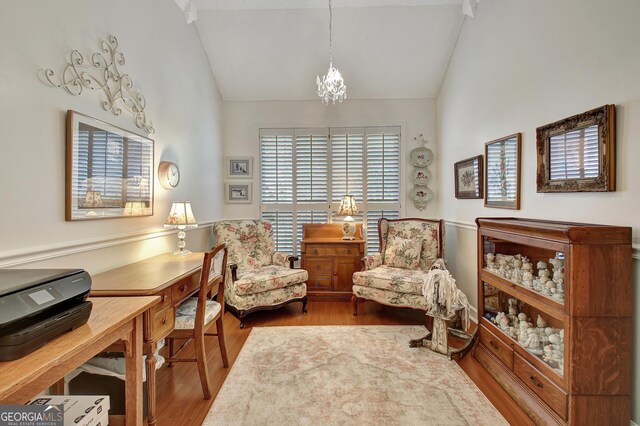 living room with a textured ceiling, light hardwood / wood-style floors, and vaulted ceiling