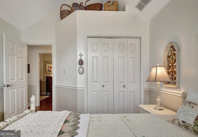 bedroom with a closet and lofted ceiling