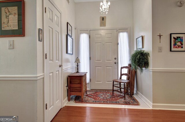 entryway with a textured ceiling and light hardwood / wood-style flooring