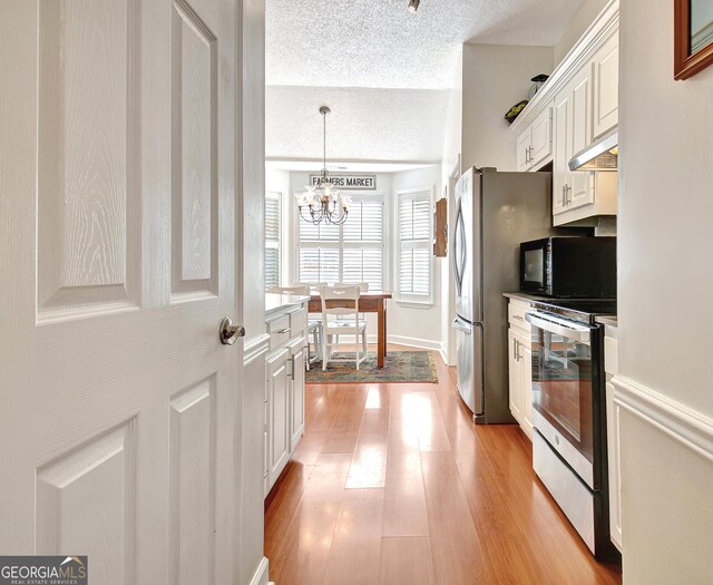 entrance foyer featuring a chandelier and wood-type flooring