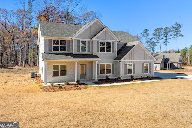 view of front facade featuring central AC unit and a front lawn