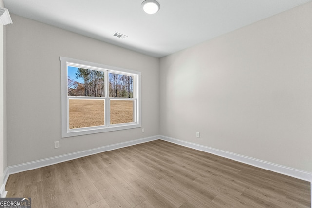 unfurnished room with light hardwood / wood-style floors