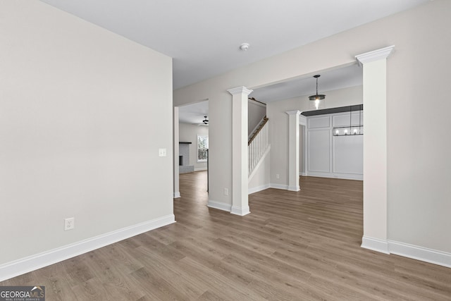 spare room with hardwood / wood-style floors, ceiling fan, and a fireplace