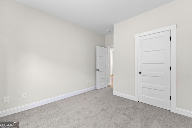 unfurnished bedroom featuring light colored carpet