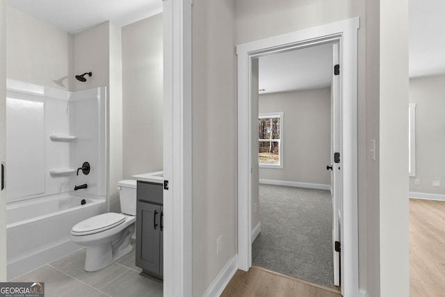 full bathroom featuring toilet, hardwood / wood-style floors, vanity, and bathing tub / shower combination