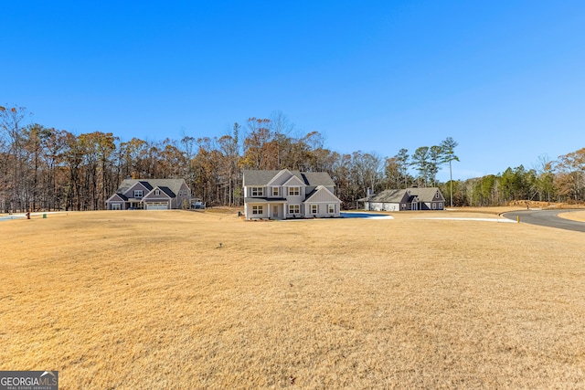 view of front of home featuring a front yard and a garage