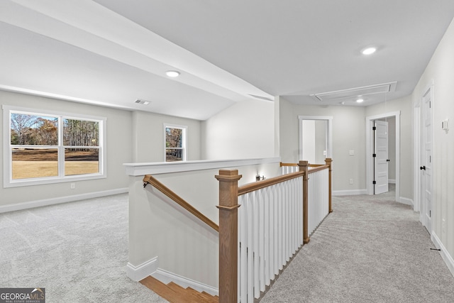 hallway featuring light carpet and lofted ceiling