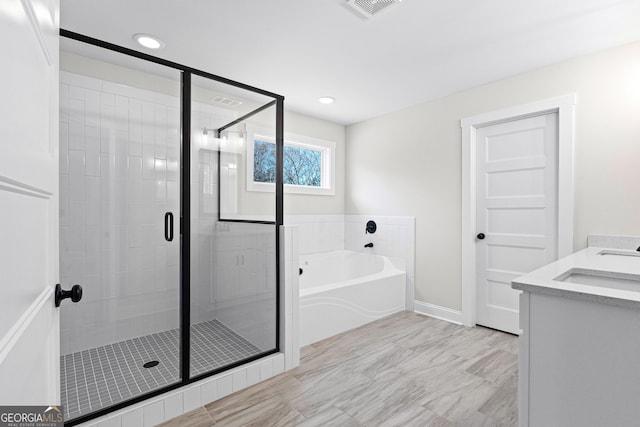 bathroom with vanity and separate shower and tub