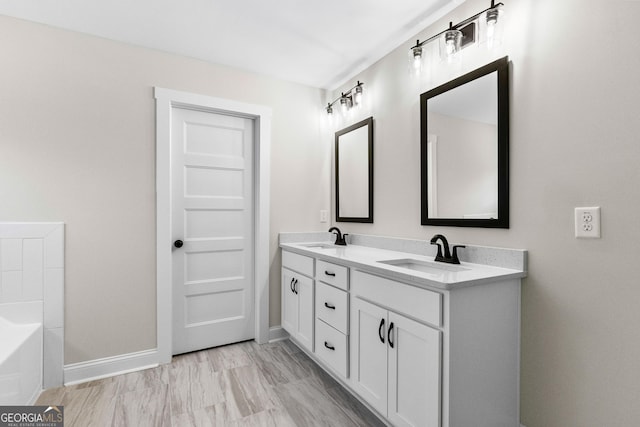 bathroom with vanity and a washtub