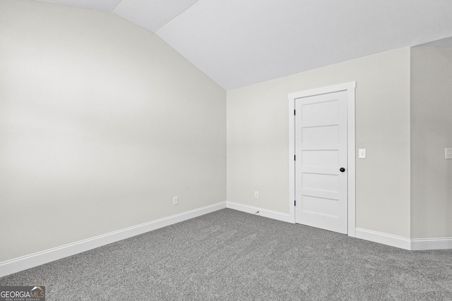 unfurnished room with carpet and lofted ceiling