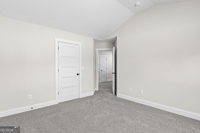 interior space with carpet flooring and lofted ceiling