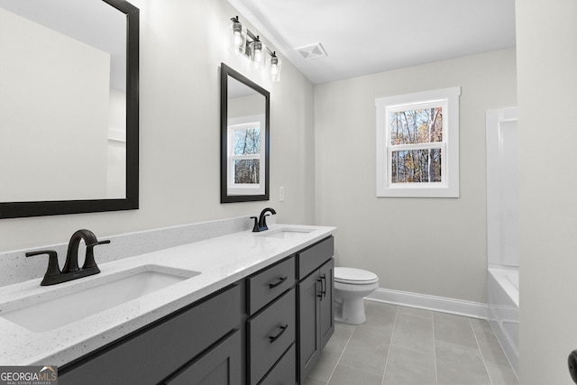 bathroom with tile patterned floors, vanity, and toilet