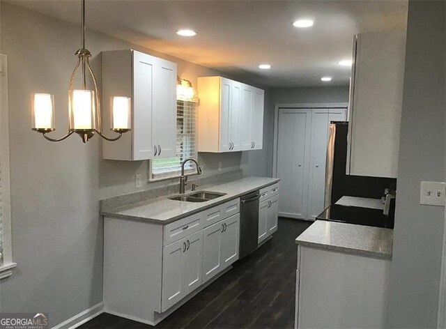 kitchen with sink, hanging light fixtures, dark hardwood / wood-style flooring, stainless steel dishwasher, and white cabinets