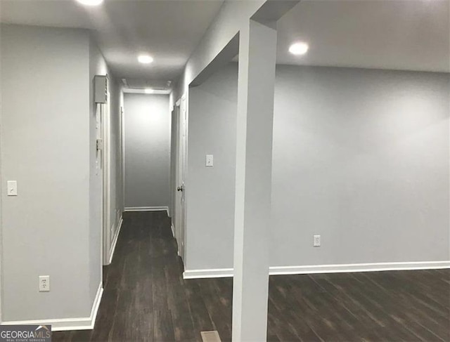 corridor with dark hardwood / wood-style flooring