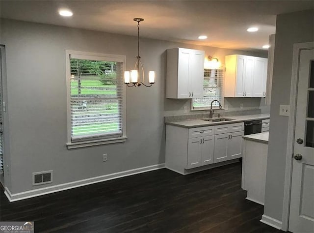 kitchen with dishwasher, white cabinets, sink, hanging light fixtures, and dark hardwood / wood-style flooring