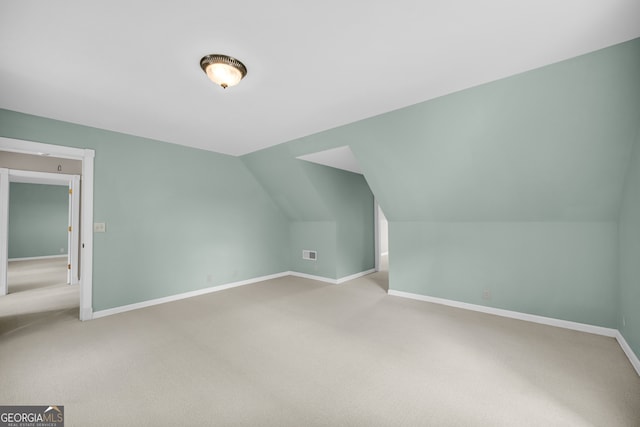 bonus room featuring carpet floors and vaulted ceiling