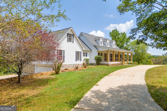 cape cod home featuring a porch, a garage, and a front lawn