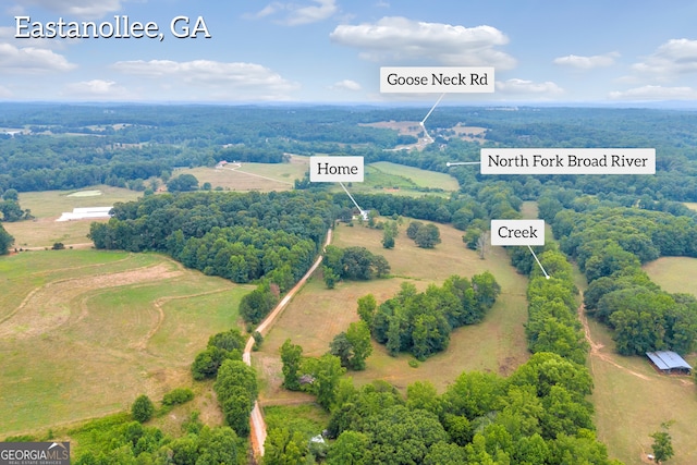 birds eye view of property with a rural view