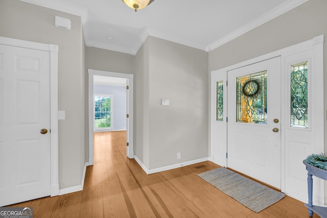 entrance foyer featuring light hardwood / wood-style flooring and ornamental molding