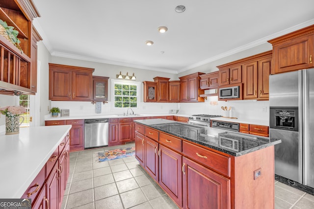 kitchen featuring crown molding, a center island, stainless steel appliances, and sink