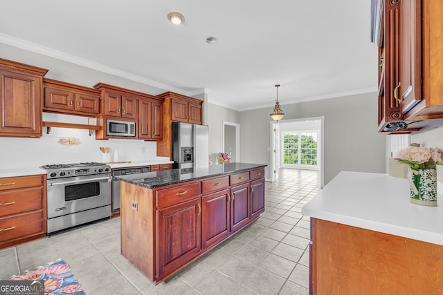 kitchen with hanging light fixtures, ornamental molding, light tile patterned floors, a kitchen island, and stainless steel appliances