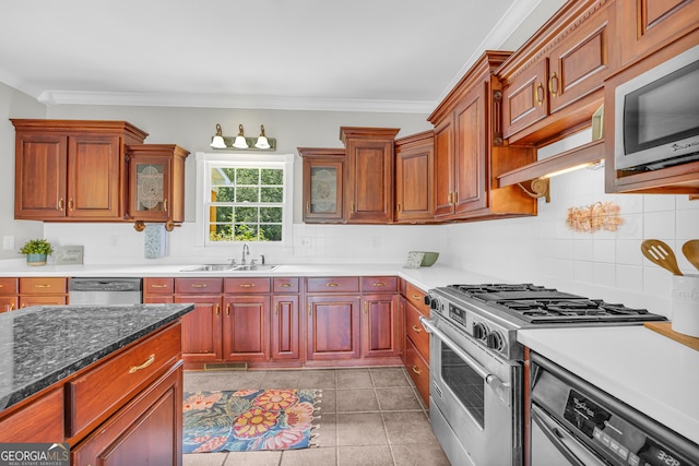 kitchen featuring backsplash, crown molding, sink, light tile patterned floors, and stainless steel appliances