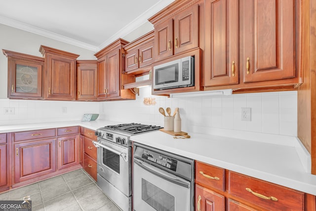 kitchen with tasteful backsplash, crown molding, light tile patterned flooring, and stainless steel appliances