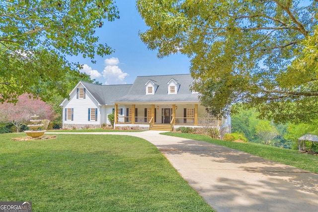 cape cod-style house featuring covered porch and a front yard