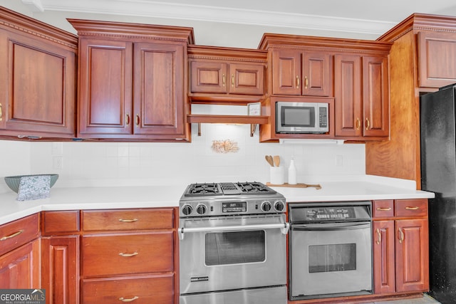 kitchen featuring backsplash, crown molding, and stainless steel appliances