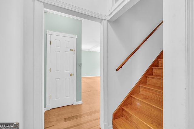 stairs featuring hardwood / wood-style floors