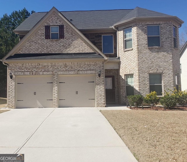 view of front of house with concrete driveway, brick siding, and an attached garage