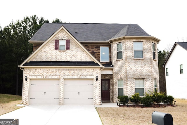 view of front facade featuring brick siding, an attached garage, and concrete driveway